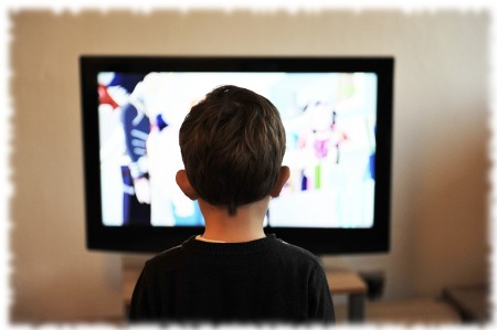 立ってテレビを見る男の子